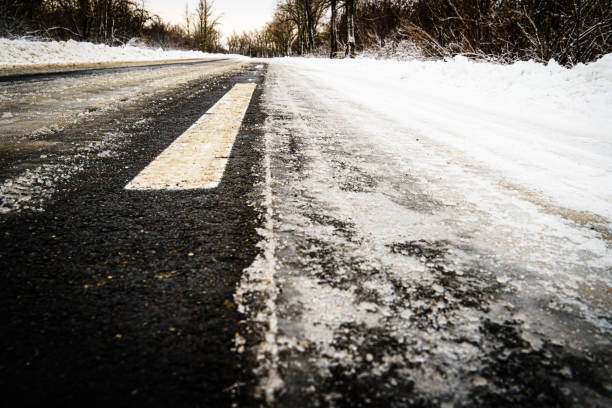 istock Road for traffic in winter, road markings under snow 1299769810