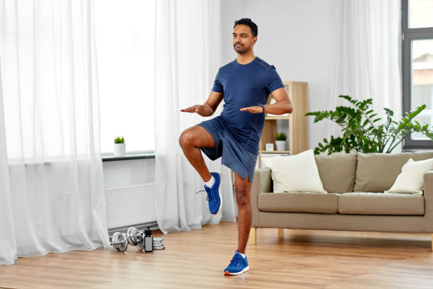 indian man running on spot at home sport, fitness and healthy lifestyle concept - indian man running on spot at home cardiovascular exercise stock pictures, royalty-free photos & images