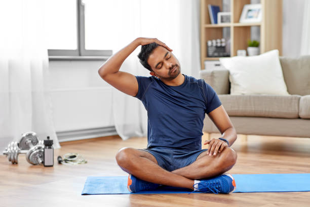 man training and stretching body at home sport, fitness and healthy lifestyle concept - indian man training and stretching body at home neck stock pictures, royalty-free photos & images