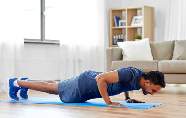 istock indian man doing push ups at home 1299770545