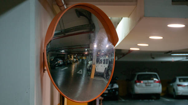 istock Curve mirror at a basement parking.Traffic mirror safety and security concept. Selective focus 1299771204