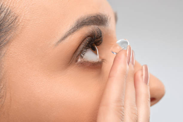 One woman holds contact lens on her finger. Eye care and the choice between the means to improve vision. One woman holds contact lens on her finger. Eye care and the choice between the means to improve vision. contact lenses for cross-dressing stock pictures, royalty-free photos & images
