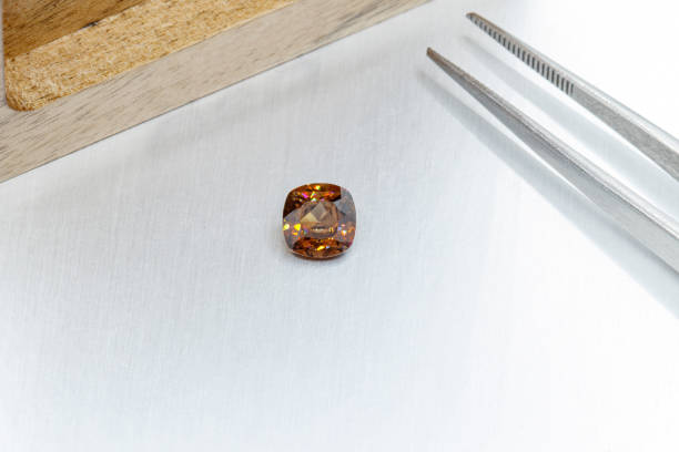 istock macro mineral faceted stone cut Zircon on a gray background 1299772679