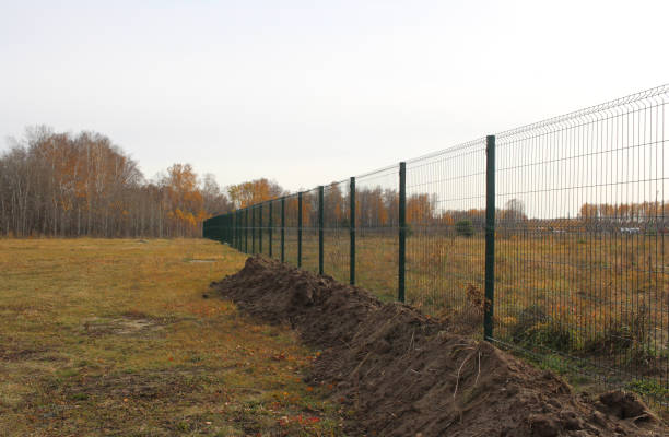 istock fenced territory behind a metal fence the land plot is closed 1299773580