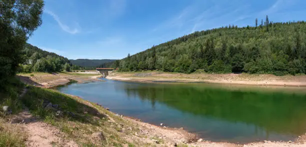 Panoramic landscape at the dam Nagoldtalsperre in the Black Forest, Germany - lower lake in summer at low water