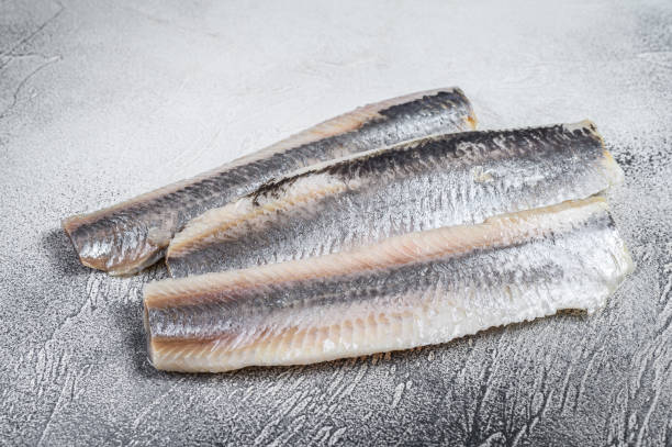 istock Pickled marinated sea herring fillet. White background. Top view 1299775416