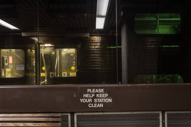 istock Train releasing passengers outside a covered waiting area with empty bench at night in downtown Chicago 1299775433