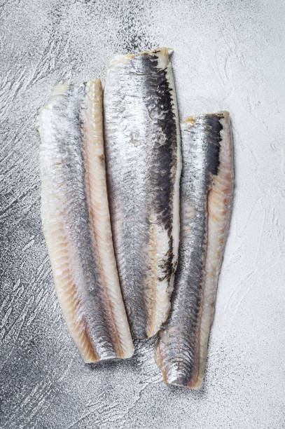 istock Pickled marinated sea herring fillet. White background. Top view 1299775436