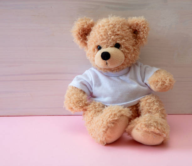 istock Teddy bear sitting on pink color floor, child room 1299775826