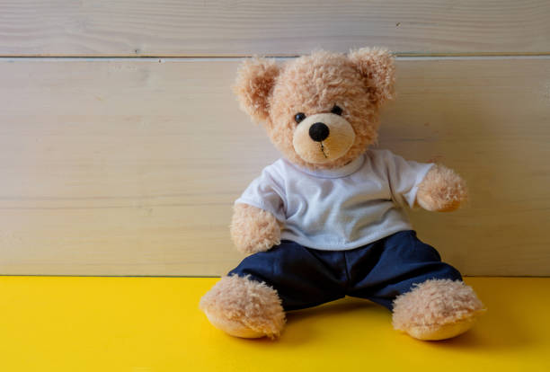 istock Teddy bear with white tshirt sitting on the floor, child room 1299775831