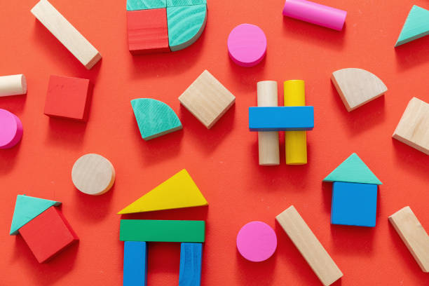 istock Wooden colorful blocks on red color background 1299775850