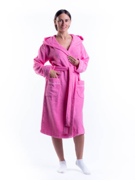istock woman in a Bathrobe on an isolated white background with a smile on her face. 1299777005