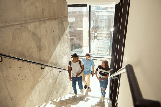 Today the first step, tomorrow the whole staircase Shot of a group of young businesspeople walking upstairs in a modern office the way forward steps stock pictures, royalty-free photos & images