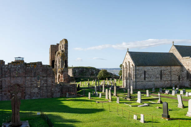 Holy Island Lindisfarne Priory ruins on sunny summer day Lindisfarne/England: 10th Sept 2019: Holy Island Lindisfarne Priory ruins lindisfarne monastery stock pictures, royalty-free photos & images