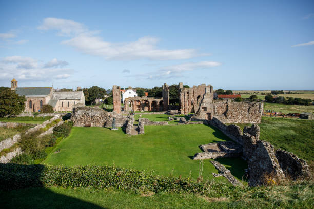Holy Island Lindisfarne Priory ruins on sunny summer day Lindisfarne/England: 10th Sept 2019: Holy Island Lindisfarne Priory ruins lindisfarne monastery stock pictures, royalty-free photos & images