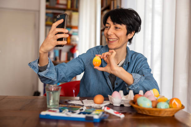 istock Woman takes a selfie with painted Easter eggs 1299780605