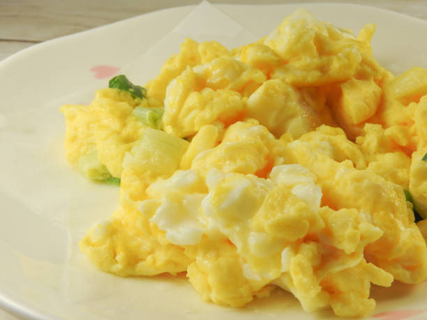 istock High angle view of a plate of yellow scrambled eggs. 1299780644
