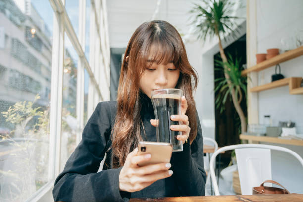 istock Woman Using Smart Phone At Cafe 1299780776
