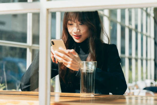 istock Woman Using Smart Phone At Cafe 1299780777