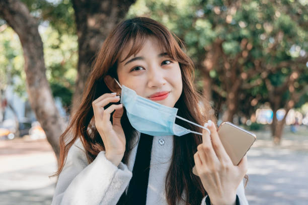istock Asian woman wearing a mask 1299780836