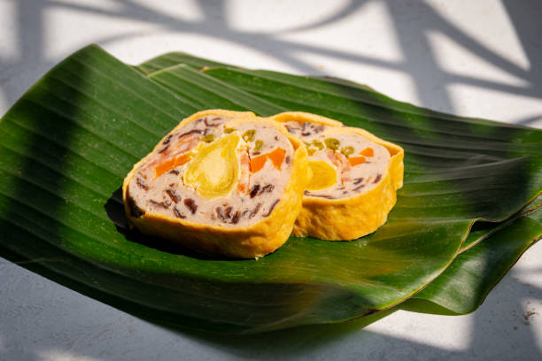 istock Mixed pork bologna roll with salted egg on green leaf decor asian food - Cha lua hoa 1299780898