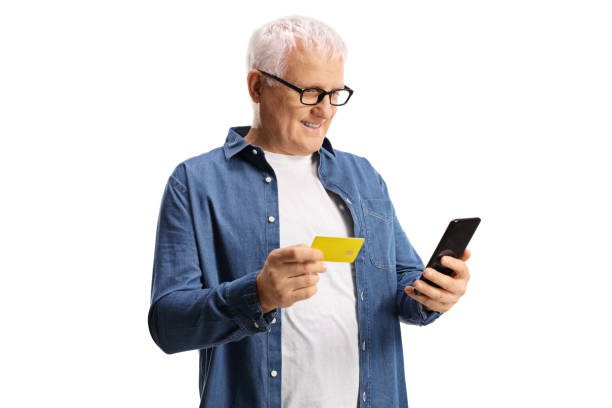 istock Casual mature man using a credit card with a mobile phone 1299781020