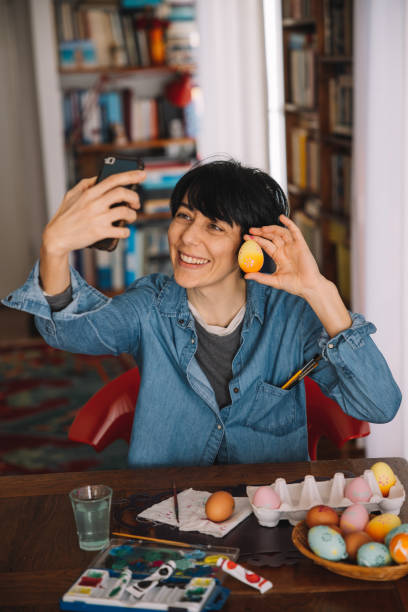 istock Woman takes a selfie with painted Easter eggs 1299781735