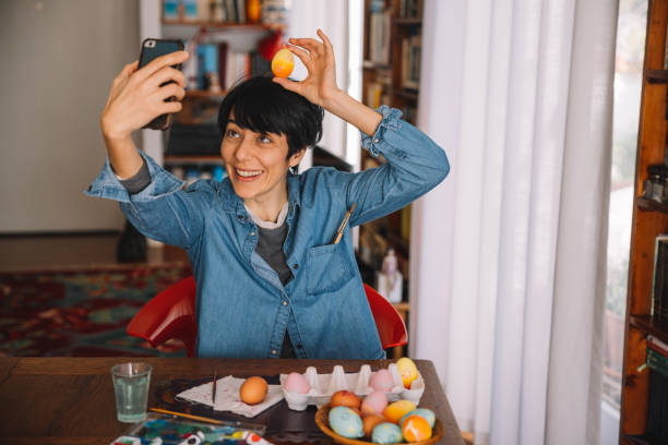 Woman takes a selfie with painted Easter eggs