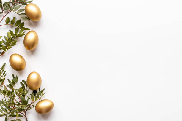 istock Golden eggs with green tree. Easter decoration background. Top view 1299782379