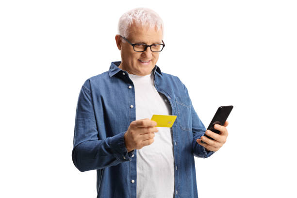 istock Mature man with a credit card and a mobile phone 1299783816