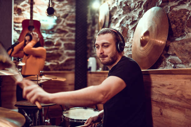istock Drummer Leading Band Into Good Song Recording 1299785392