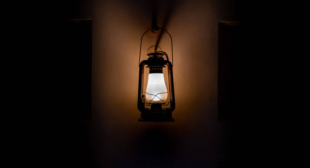 istock old arab kerosene lamp hanging on the wall in darkness. 1299785440