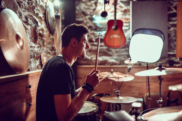 istock Modern Male Drummer Practicing Song Before Music Video Recording 1299785509