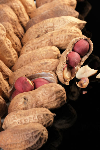 istock Boxes of peanut nuts fried close-up 1299790494