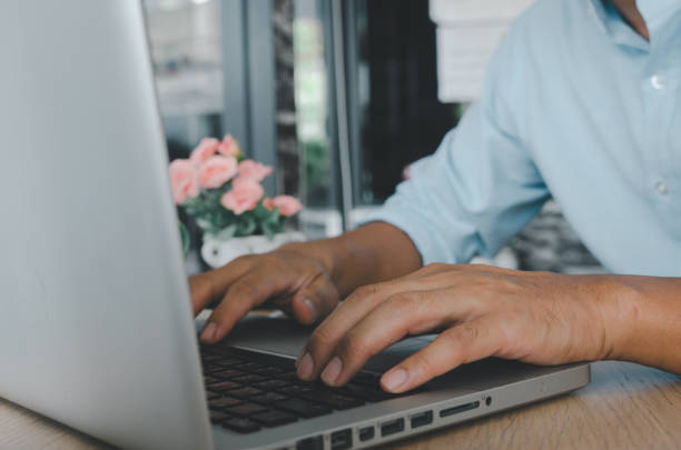 istock business man hand typing on laptop computer keyboard  on table.searching internet technology. Social media online business concept 1299791579