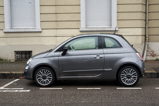 Mulhouse - France - 31 January 2021 - Profile view of Gray Fiat 500 car, the famous italian brand of cars parked in the street