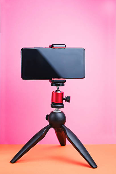 istock tripod with smartphone on bright purple background 1299793322