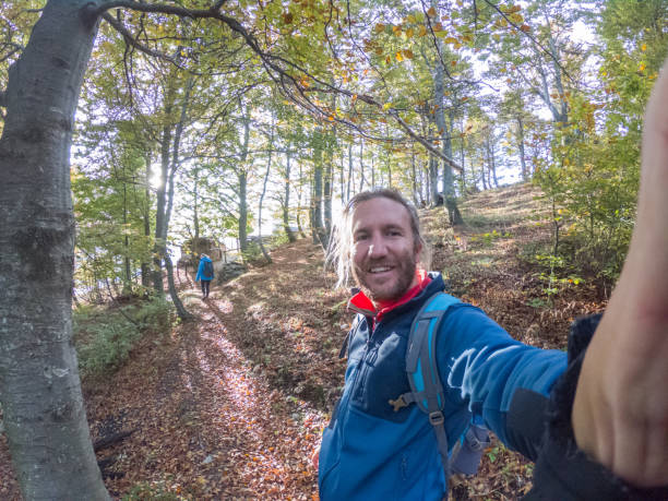 istock Cheerful man taking a selfie portrait in the forest 1299794943