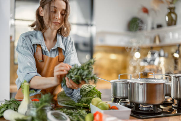 istock Woman with green ingredients on the kitchen 1299795538