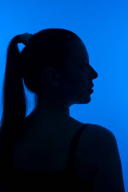 istock White woman silhouette - vertical silhouette 1299795843