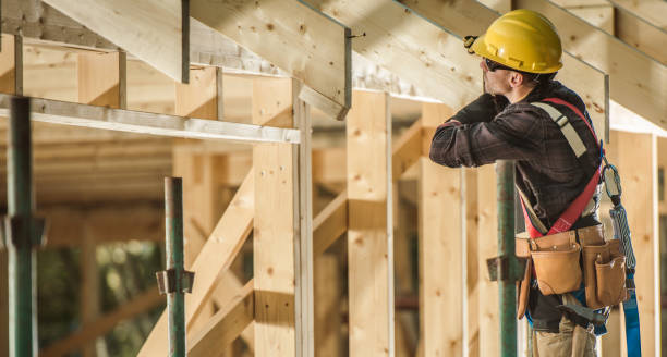 istock Construction Worker and Newly Built Wooden Roof Frame 1299796558
