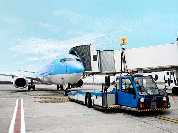 airplane in airport cargo airplane being loaded on an airport passenger boarding bridge stock pictures, royalty-free photos & images