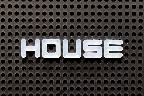 istock White color alphabet with word house on black pegboard background 1299799941