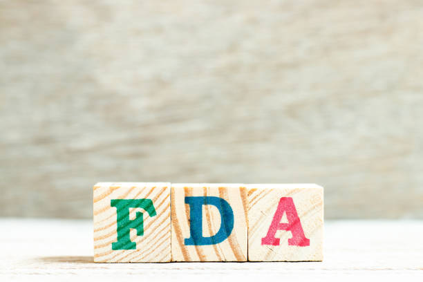 Alphabet letter in word FDA (abbreviation of food and drug administration) on wood background Alphabet letter in word FDA (abbreviation of food and drug administration) on wood background food and drug administration stock pictures, royalty-free photos & images