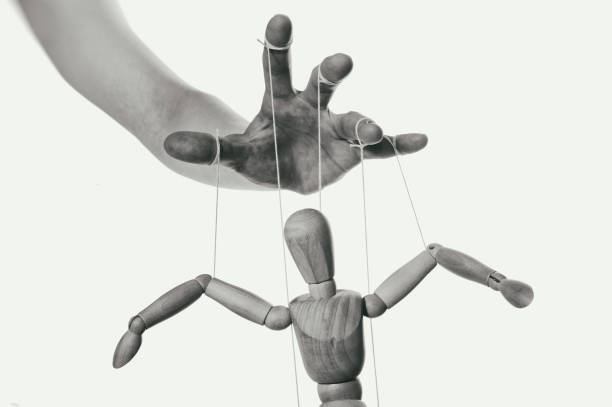 Concept of control. Close-up. Concept of control. Marionette in human hand. Close-up. Black and white. marionette stock pictures, royalty-free photos & images