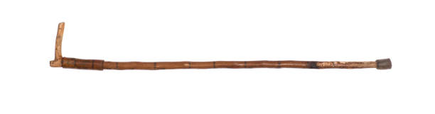 istock old wood cane isolated on wooden background 1299803388