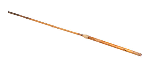 istock wooden pointer, old wood cane isolated on wooden background 1299803429