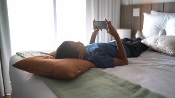 istock Child boy playing on smartphone at home 1299804745
