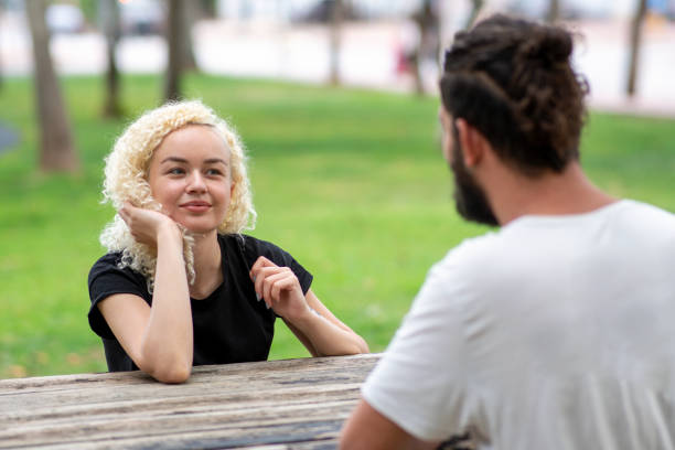 istock Couple meeting at park 1299805142