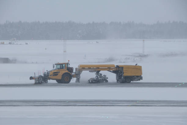 istock Airplane runway snow plower cleaning the runway. 1299805387